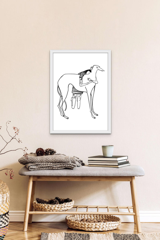 Black line drawing of tattooed girl in stripy dress hugging large derpy greyhound/lurcher/sighthound on white background print in white frame hanging on a wall